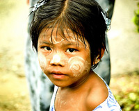 Burmese girl with face paint on.